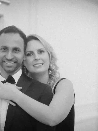 A warm and loving embrace captured in timeless black and white. This indoor pre-wedding portrait is simple and elegant, focusing entirely on the couple's happy expressions and connection.