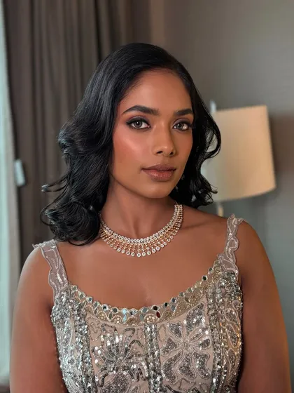 For this gorgeous reception bride, I wanted to create a true "goddess glow". I focused on a flawless, luminous base to celebrate her beautiful dusky skin tone, paired with a sultry brown smokey eye and a nude lip for a look that is pure glamour.