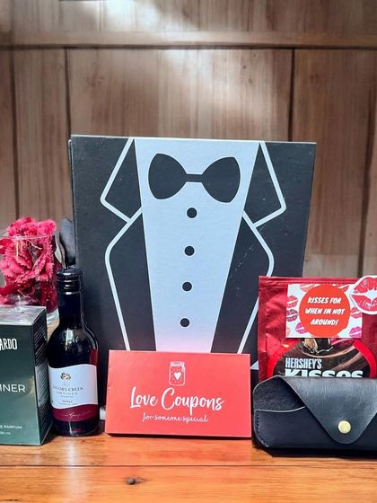 A fun and romantic gift box for him, designed to look like a tuxedo. Inside, it holds a bottle of wine, perfume, love coupons, and other treats for a special occasion.