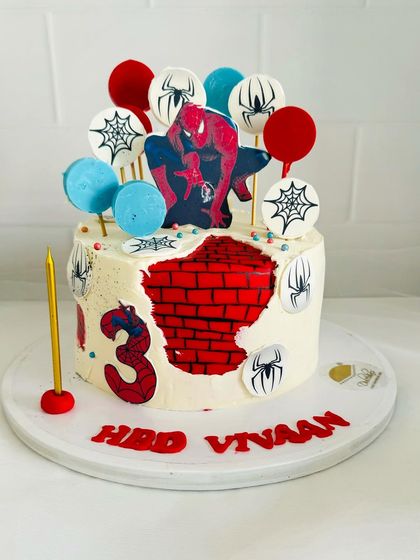 Another take on a Spider-Man theme, this cake uses stenciling and toppers to create a dynamic look.