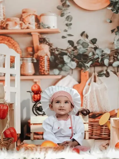 A sweet little chef in a beautifully detailed kitchen setup. The shelves are stocked with spices and ingredients, creating a realistic and charming scene.