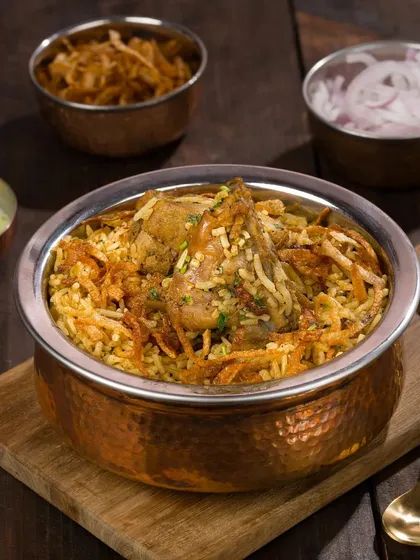Biryani is all about aroma and texture. We use specific lighting and styling techniques, like showcasing the fried onions and tender chicken, to make this classic dish look as mouth-watering as it smells.