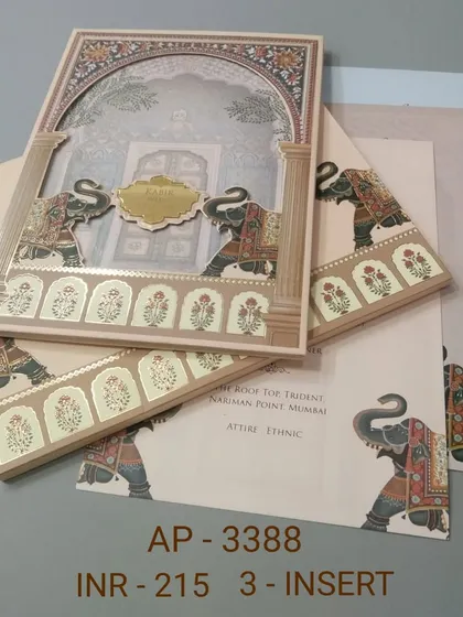 A beautiful laser-cut frame reveals a scene with two majestic elephants on this beige invitation card. This set comes with three inserts, making it ideal for detailing multiple wedding events like the Mehendi and Sangeet.