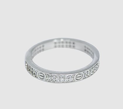 Our popular American Diamond band, inspired by high-end luxury designs. This ring is fully encrusted with zirconia and features screw-head motifs for a chic, modern look.