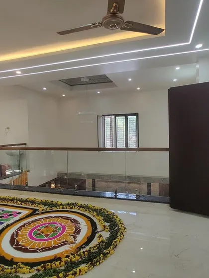 A duplicate image of the upper living space, showing the beautiful rangoli and open terrace connection.