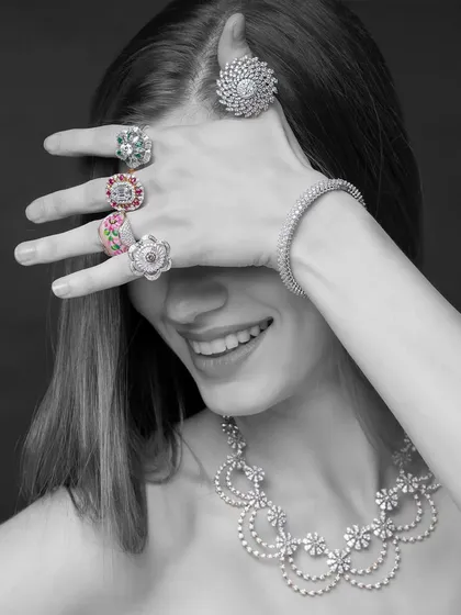 A playful and candid-style shot for Yoube Jewellery. The monochrome treatment keeps the focus on the incredible sparkle of the diamond rings and necklace, while the model's smile adds a touch of joy and personality.