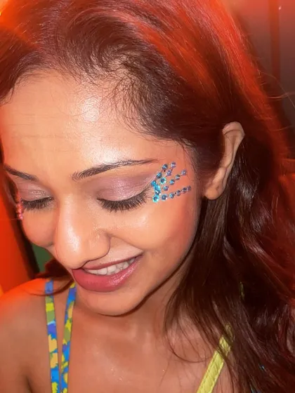 A delicate pattern of blue gems applied under the eye. This is a great way to add sparkle without using loose glitter.