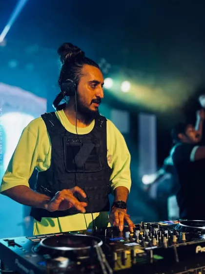 A duplicate of image 58, showing my concentration while mixing at the large-scale auto expo event in Kerala.