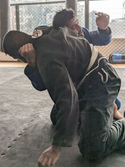 Close-up of a grip fight during a Gi sparring session. This is where the battle for control begins, using the uniform to establish dominance.