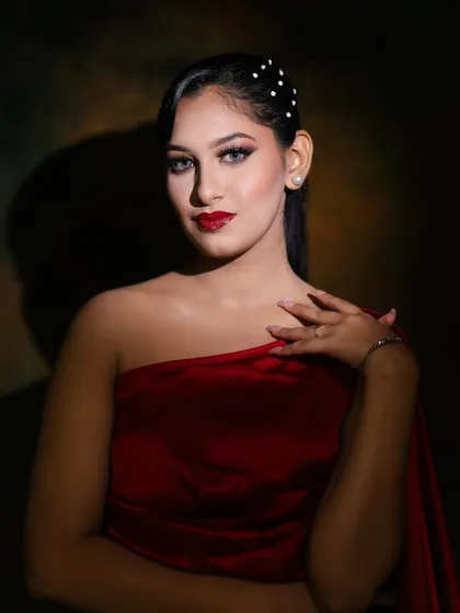 A softer, more dramatic lighting shot that highlights the model's features and the flawless makeup.