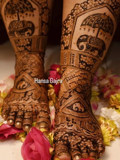 A stunning full-coverage leg design featuring royal elephants under a chatri (umbrella). The feet are adorned with intricate patterns, creating a look of pure grandeur.