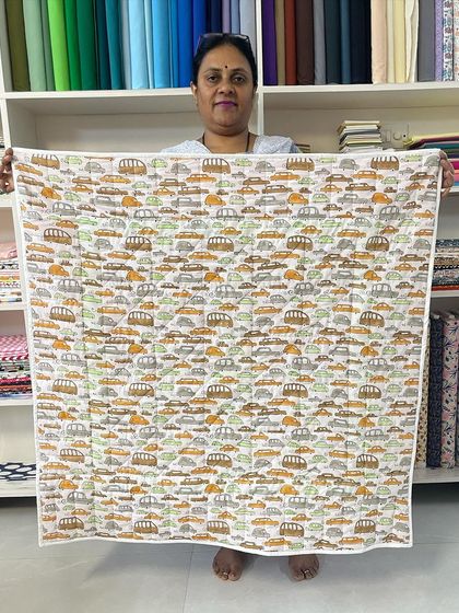 The reverse side of the beginner's quilt, featuring a playful car-themed fabric, perfect for a child's gift.