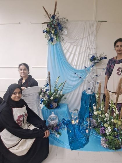 This winter-themed display in cool blues and whites showcases our students' ability to create a cohesive and evocative scene. The design includes a backdrop, multiple arrangements, and themed props.