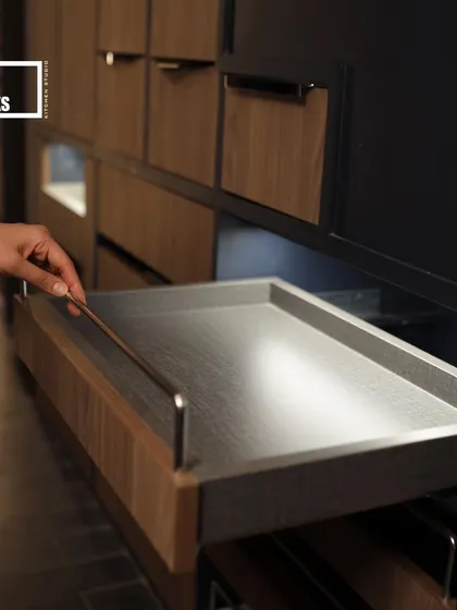 A shallow pull-out tray is perfect for organizing smaller items or serving accessories, ensuring nothing gets lost in the back of the cabinet.