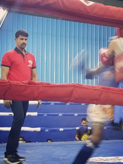 Watching the action closely from the side of the ring. As a coach, I analyze every move to give the best advice between rounds.