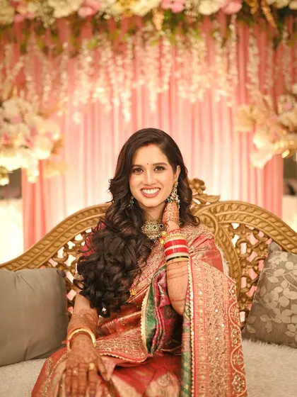 A beautiful, smiling portrait of the bride, looking directly at the camera with confidence and joy.