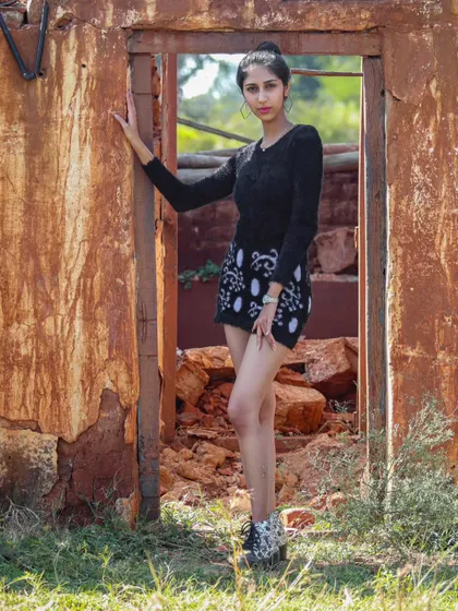 A standing pose in a doorway, using the architecture of the ruins to frame the shot.