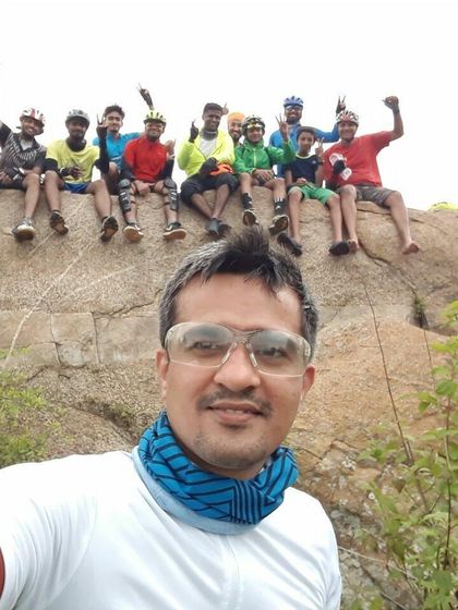A selfie capturing the smiling faces of the crew as they relax on a rock formation.