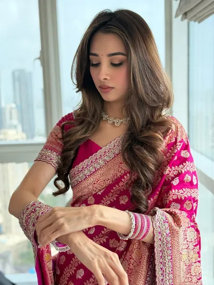A serene, eyes-down pose. This highlights the soft eyeshadow and the flawless finish of her skin.