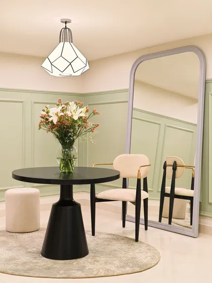 A small, elegant meeting spot in our office. The combination of the sculptural black table, modern chairs, and a large arched mirror creates a sophisticated corner for informal discussions or a quick coffee break.