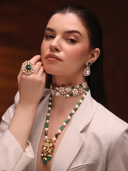 For this high-fashion jewelry shoot, the makeup had to be elegant and strong without overpowering the stunning emeralds. I created a sculpted, earthy look with a matte lip and defined eyes to complement the modern-meets-traditional styling.