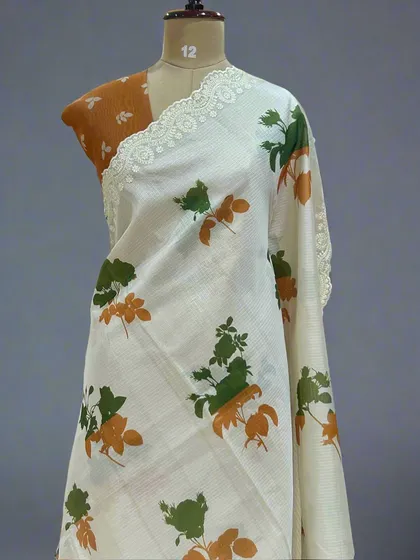 The same Kota checks saree design, this time with earthy green and orange floral prints.