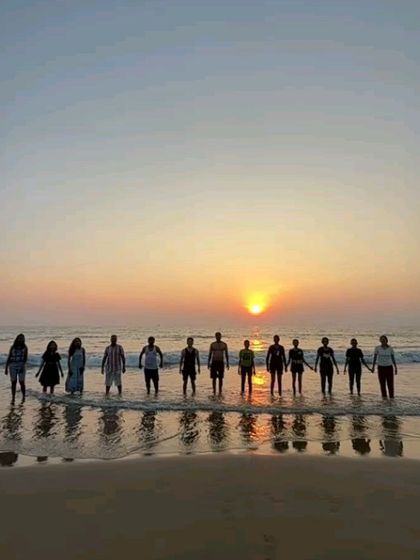 A silhouette of the group holding hands against the setting sun, a perfect end to the day.