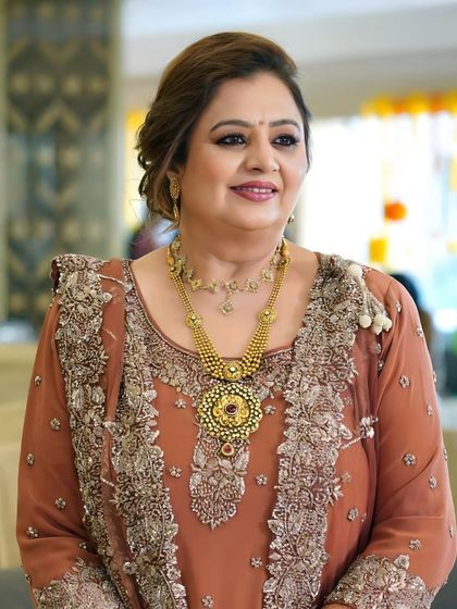 A glowing look for the mother of the groom for the dhol party. The makeup is warm and celebratory, with a focus on enhancing her natural features to match the festive occasion.