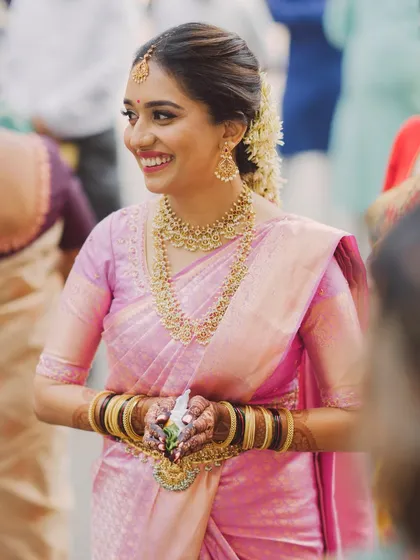 A candid shot of Lithika during her wedding ceremony. The makeup looks fresh and stays put, ensuring she looks her best throughout the day's events.