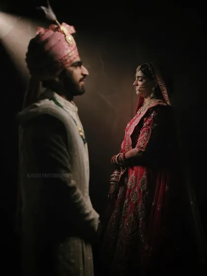 A dramatic couple portrait using a single light source to create a moody, intimate atmosphere. This highlights my artistic approach to wedding photography, focusing on emotion and connection.