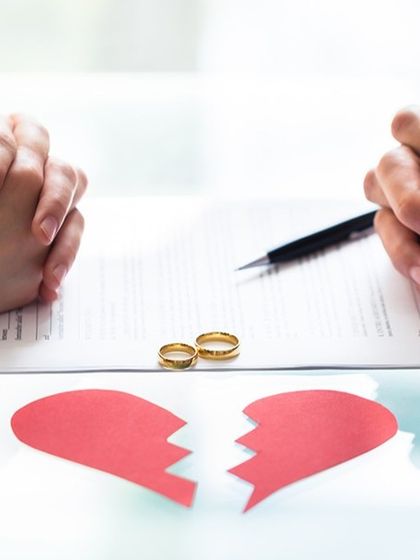 Two people sitting across a table with a broken heart signifies the difficult decision to separate. I provide expert legal advice to help you navigate this challenging time with clarity and confidence.