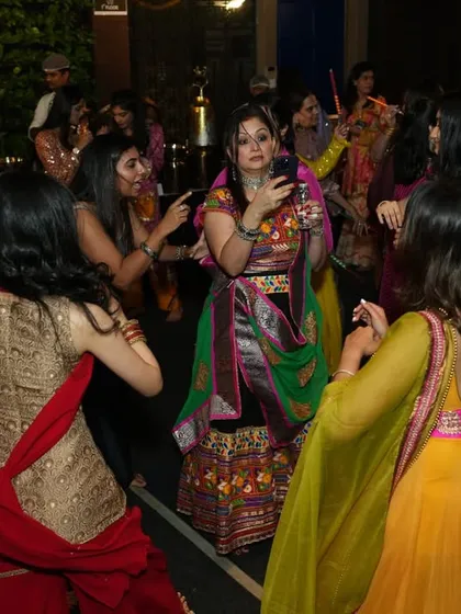 The dance floor is packed during a vibrant Garba night. I love seeing the crowd, dressed in colorful traditional attire, enjoying the music and dancing together.