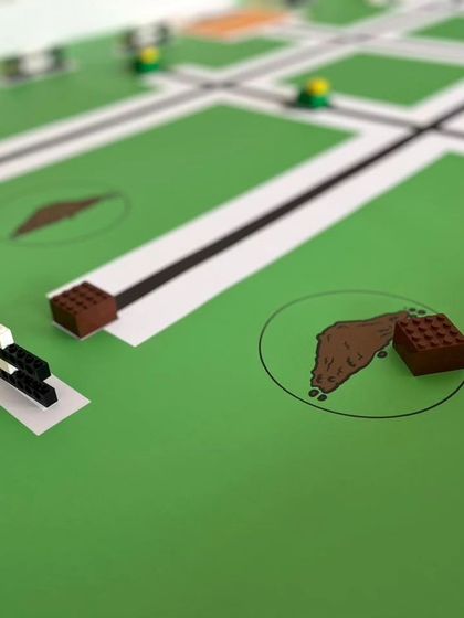 Detail of the IRO Techies challenge mat, showing specific zones and obstacles the robots must navigate. These elements test the students' design and programming skills.