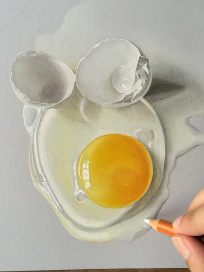 A realistic drawing of a broken egg. I used colored pencils to capture the delicate texture of the shell and the glossy, wet look of the yolk and whites.