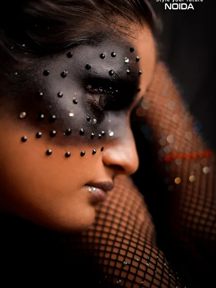 A detailed side profile of the studded mask. This highlights the intricate application of each stud, showcasing the precision taught in our courses.
