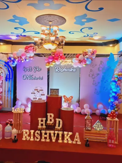 "Isn't she ONEderful?" This butterfly-themed first birthday is full of charm. I used red and pink plinths, marquee letters for the name, and butterfly details throughout the stage setup.