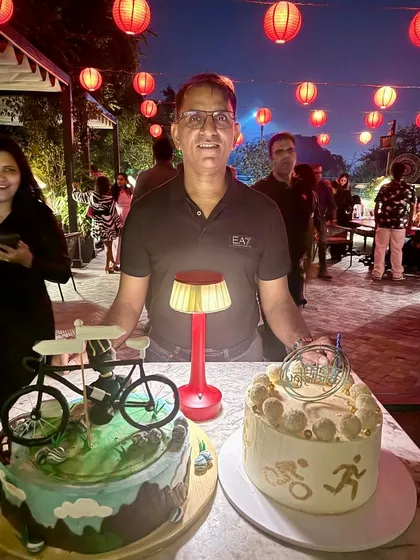 The man of the hour, posing with his incredible cycling-themed birthday cakes.