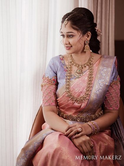 A seated portrait showing the full look with her pastel saree.