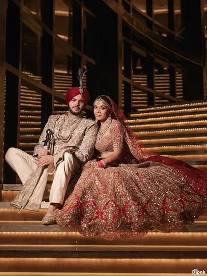 A portrait of regal elegance, where every detail tells a story of heritage and love. This moment from a grand Sikh wedding captures the couple's majestic presence against a backdrop of architectural splendor. My goal is to create timeless portraits that feel like a part of your family's legacy.