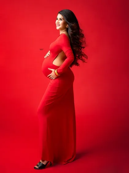 A full-length view of this stunning red maternity gown, showing its elegant train and flattering fit.