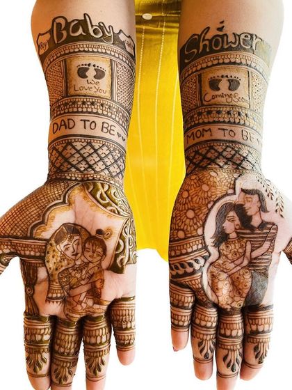 This design combines a traditional Yashoda and Krishna portrait with a modern portrait of the expecting couple. The forearms feature baby footprints and the words "Baby Shower," "We Love You," and "Coming Soon."