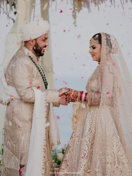During their seaside Nikah ceremony in Thailand, the bride and groom exchange vows as flower petals rain down. This is the heart of my work: capturing the profound, emotional promises that are made, framed by the beauty of the destination.
