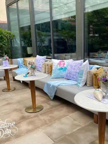 Lounge seating with custom-printed mermaid cushions.