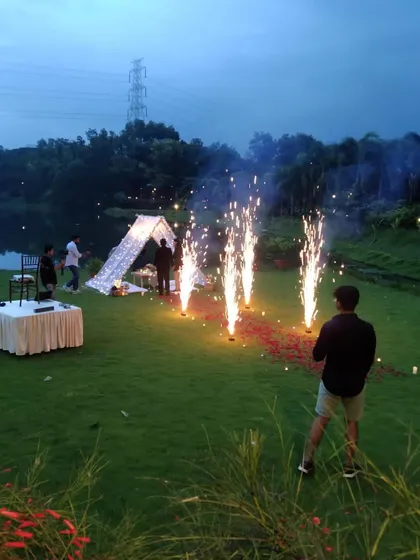 I create magical moments in any setting. This romantic anniversary picnic by the lake, complete with a beautiful tent, fairy lights, and cold pyro fireworks, shows how I can turn an outdoor space into a private, unforgettable experience.