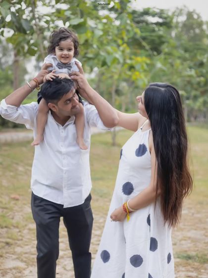 A playful moment with dad lifting his son onto his shoulders while mom looks on. These are the candid memories we love to capture.