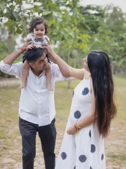 A playful family moment with the toddler sitting on dad's shoulders. These fun, interactive shots are a wonderful way to show your family's personality.
