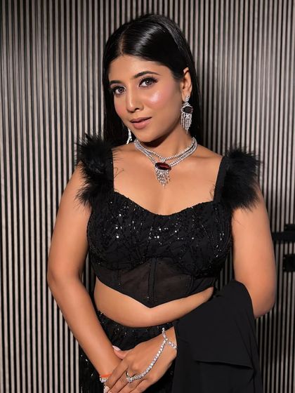 A full portrait of the model in the black lehenga, showcasing its chic and sophisticated vibe. A perfect rental for a formal evening event.