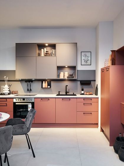 A playful and elegant kitchen in shades of dusty pink and mauve, demonstrating our ability to create truly personalized and unique color palettes.