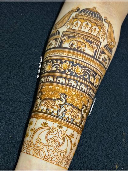 The bridal arm design extended with more layers of patterns. This view shows the addition of elephant processions and floral bands below the main palace motif.