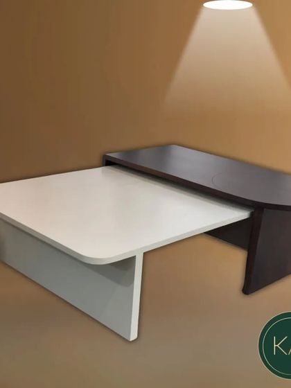 A two-tone, multi-level coffee table in our workshop. This piece, with its contrasting finishes and modern design, is a testament to our creative and functional approach to furniture making.